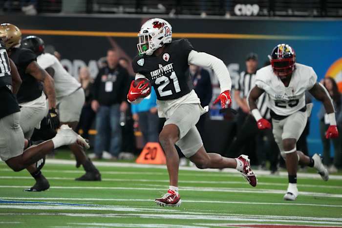 Feb 2, 2023; Las Vegas, NV, USA; West cornerback Nic Jones of Ball State (21) carries the ball on an interception return against the East during the Shrine Bowl at Allegiant Stadium. Mandatory Credit: Kirby Lee-USA TODAY Sports